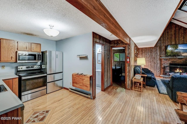 24 Lakewood Dr, Lake Ariel, PA 18436 - kitchen with stainless steel appliances, wooden walls, a textured ceiling, light wood-style flooring, and light countertops