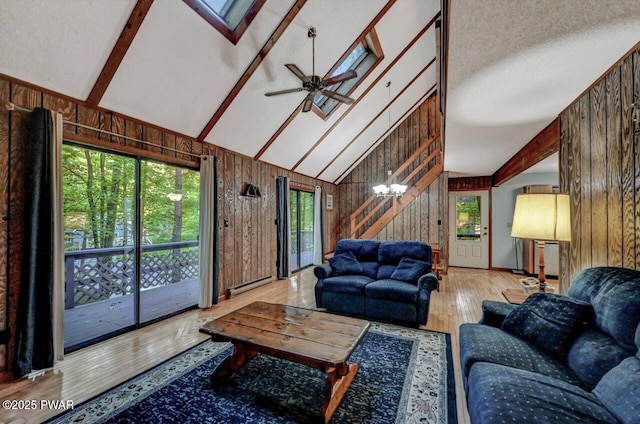 24 Lakewood Dr, Lake Ariel, PA 18436 - living room featuring wooden walls, wood finished floors, high vaulted ceiling, a baseboard heating unit, and ceiling fan