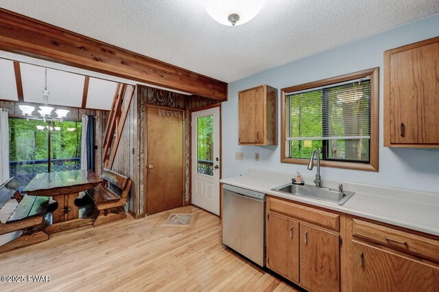 24 Lakewood Dr, Lake Ariel, PA 18436 - kitchen with stainless steel dishwasher, a sink, light countertops, a chandelier, and light wood finished floors