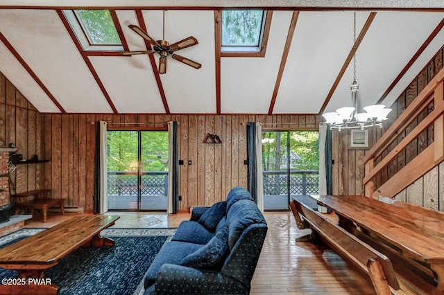 24 Lakewood Dr, Lake Ariel, PA 18436 - living area featuring a skylight, wood-type flooring, vaulted ceiling, a chandelier, and a ceiling fan