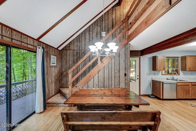 24 Lakewood Dr, Lake Ariel, PA 18436 - dining area with wooden walls, light wood finished floors, a chandelier, and stairway