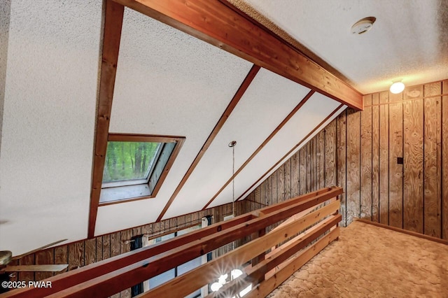 24 Lakewood Dr, Lake Ariel, PA 18436 - stairway with a skylight, wooden walls, carpet floors, and a textured ceiling