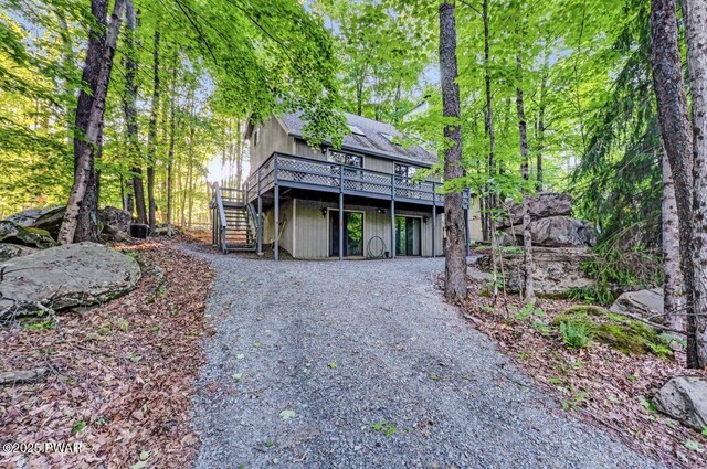 24 Lakewood Dr, Lake Ariel, PA 18436 - view of front of property featuring stairway, a deck, driveway, and a shingled roof