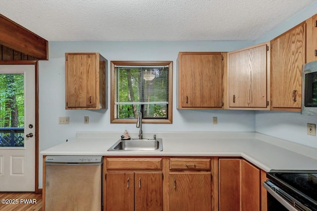 24 Lakewood Dr, Lake Ariel, PA 18436 - kitchen with appliances with stainless steel finishes, a sink, light countertops, healthy amount of natural light, and a textured ceiling