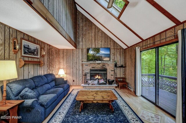 24 Lakewood Dr, Lake Ariel, PA 18436 - living area featuring wooden walls, high vaulted ceiling, wood finished floors, a fireplace, and beam ceiling