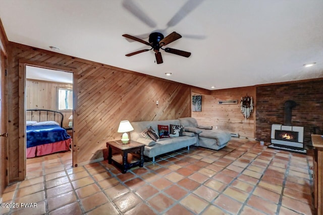 24 Lakewood Dr, Lake Ariel, PA 18436 - living room featuring wooden walls, a ceiling fan, tile patterned flooring, a wood stove, and recessed lighting