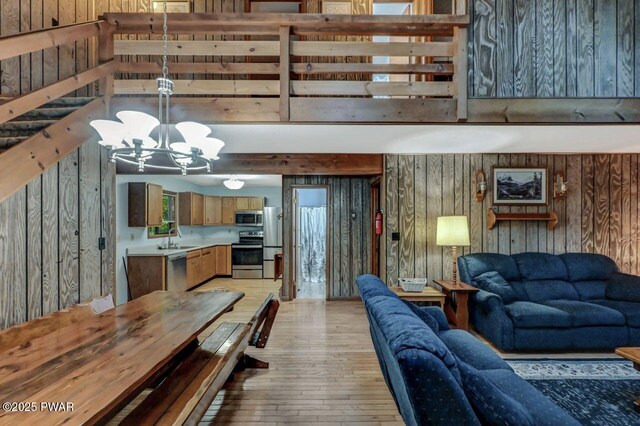 24 Lakewood Dr, Lake Ariel, PA 18436 - living room featuring light wood-style flooring, a chandelier, and wooden walls