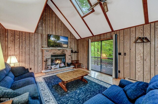 24 Lakewood Dr, Lake Ariel, PA 18436 - living room with wood walls, a brick fireplace, wood finished floors, a skylight, and high vaulted ceiling