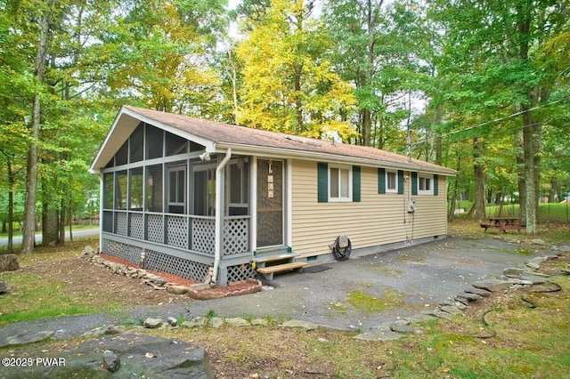 exterior space featuring entry steps and a sunroom