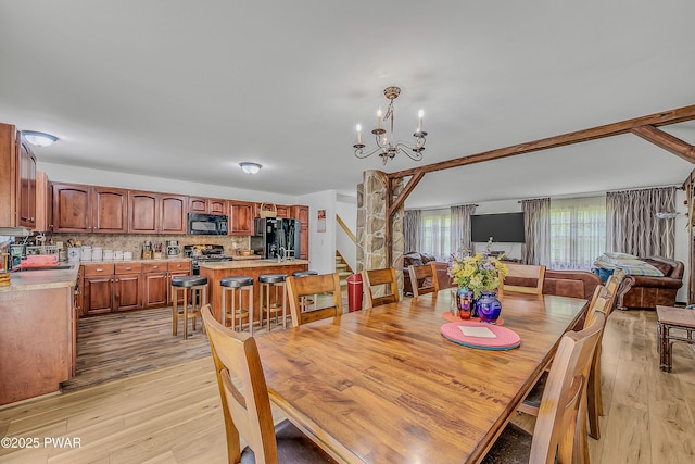 2106 Blueberry Ct, Bushkill, PA 18324 - dining area featuring light wood-style flooring, stairway, and a chandelier
