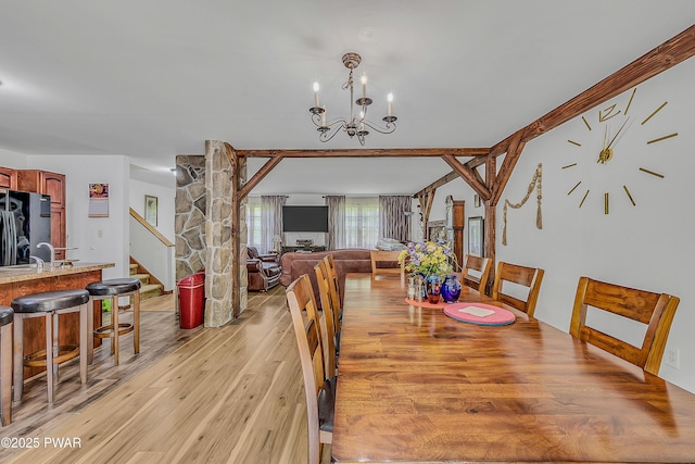 2106 Blueberry Ct, Bushkill, PA 18324 - dining space featuring light wood-style flooring, stairs, and a chandelier