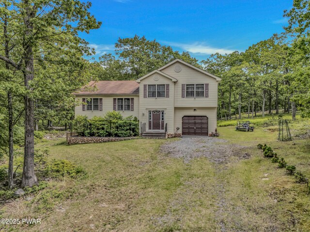 2106 Blueberry Ct, Bushkill, PA 18324 - tri-level home featuring an attached garage, a front yard, and driveway