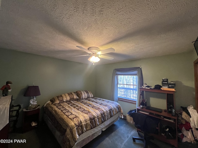 carpeted bedroom with ceiling fan and a textured ceiling