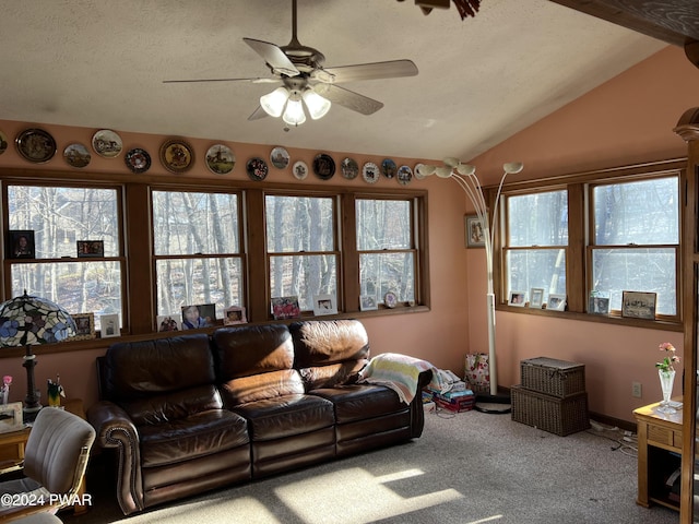 living room with carpet flooring, a textured ceiling, ceiling fan, and lofted ceiling