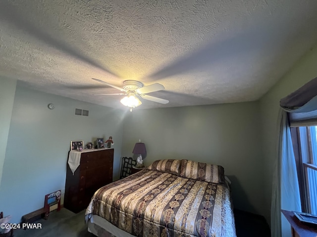 bedroom featuring a textured ceiling, carpet floors, and ceiling fan