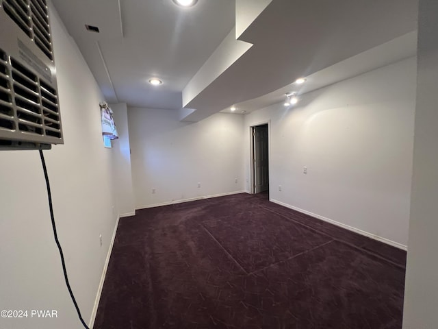 basement featuring dark carpet