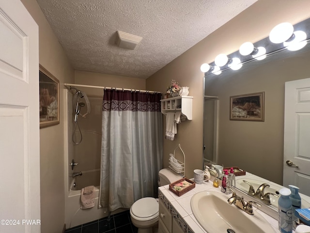 full bathroom featuring vanity, a textured ceiling, shower / bathtub combination with curtain, tile patterned flooring, and toilet