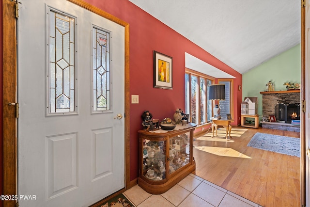 100 Blue Shelf Ln, Lords Valley, PA 18428 - tiled foyer entrance featuring a fireplace and lofted ceiling