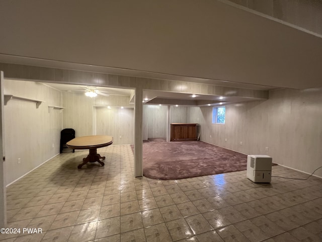 basement featuring wooden walls