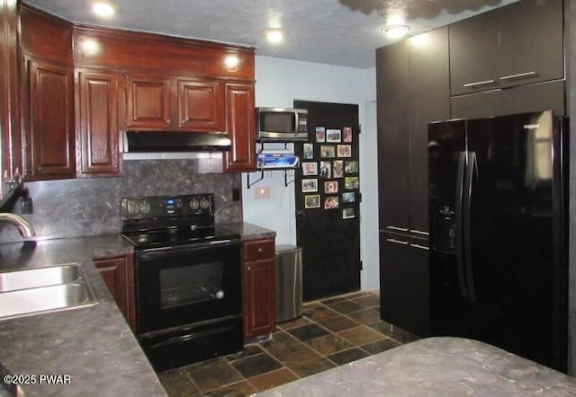 102 Yvonne Ct, Dingmans Ferry, PA 18328 - kitchen with under cabinet range hood, tasteful backsplash, a sink, stone finish flooring, and black appliances
