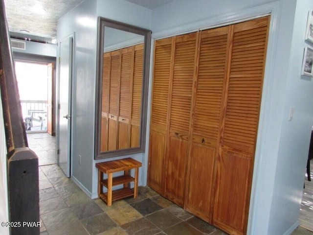 102 Yvonne Ct, Dingmans Ferry, PA 18328 - corridor featuring visible vents and stone finish floor