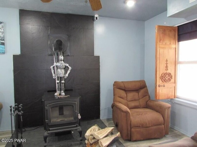 102 Yvonne Ct, Dingmans Ferry, PA 18328 - living room featuring baseboards, ceiling fan, and a wood stove