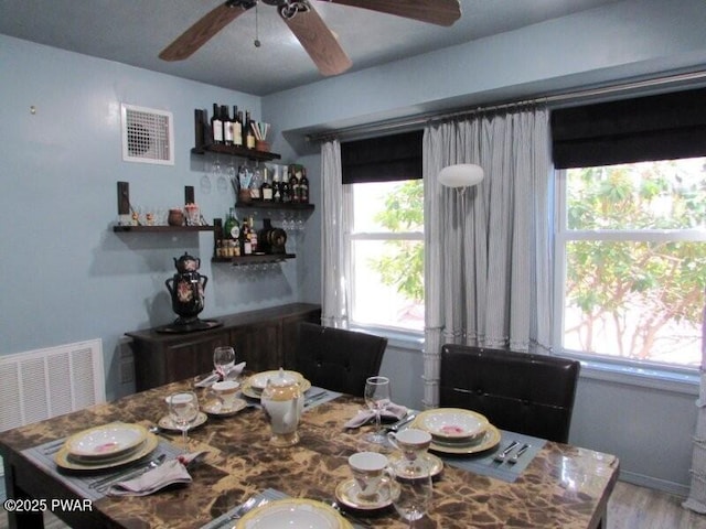 102 Yvonne Ct, Dingmans Ferry, PA 18328 - dining room featuring a ceiling fan, visible vents, plenty of natural light, and a dry bar