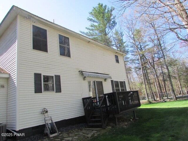 102 Yvonne Ct, Dingmans Ferry, PA 18328 - rear view of house with a lawn and a wooden deck
