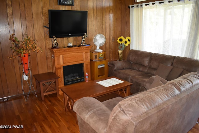 living room with hardwood / wood-style flooring and wood walls