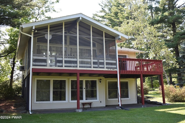 back of house with a sunroom and a yard