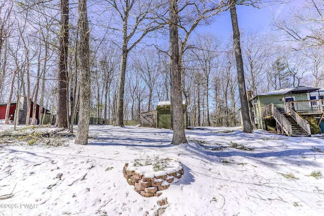 snowy yard featuring stairs