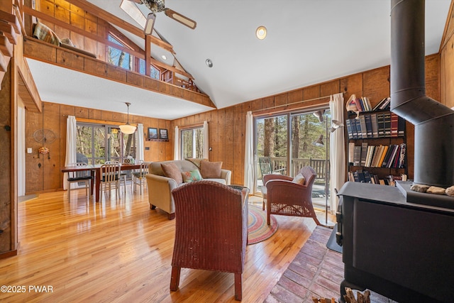 105 Tupelo Dr, Lords Valley, PA 18428 - living room with wood walls, healthy amount of natural light, ceiling fan, light wood finished floors, and a wood stove