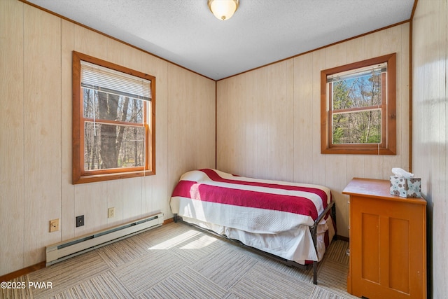 105 Tupelo Dr, Lords Valley, PA 18428 - bedroom featuring a baseboard heating unit, a textured ceiling, wooden walls, and crown molding