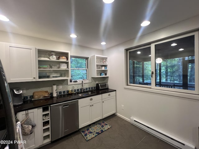 kitchen featuring white cabinets, dishwasher, dark tile patterned floors, a baseboard heating unit, and sink