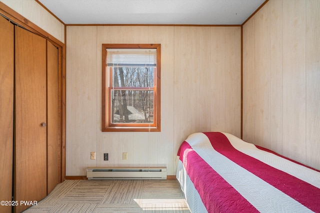 105 Tupelo Dr, Lords Valley, PA 18428 - carpeted bedroom featuring a baseboard radiator and wood walls