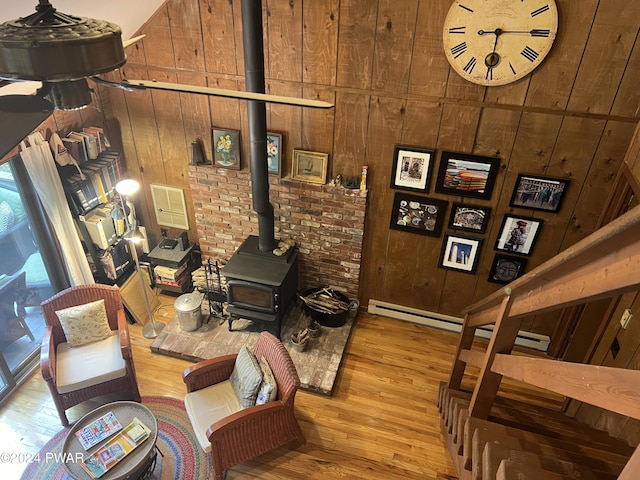 living room featuring light hardwood / wood-style flooring and wood walls