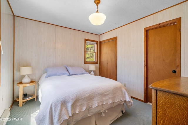 105 Tupelo Dr, Lords Valley, PA 18428 - bedroom featuring crown molding, carpet, a closet, and wooden walls