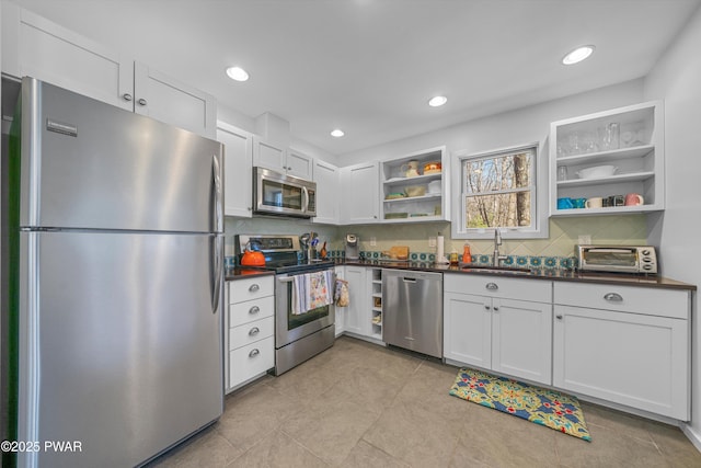 105 Tupelo Dr, Lords Valley, PA 18428 - kitchen with stainless steel appliances, open shelves, dark countertops, backsplash, and white cabinetry