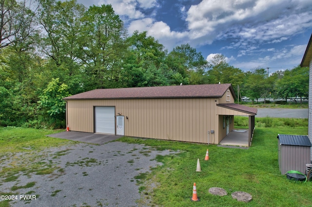 view of outdoor structure with a lawn and a garage