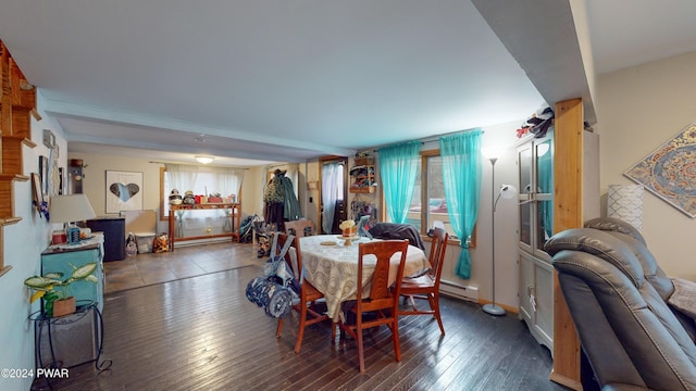 dining space with dark hardwood / wood-style flooring and a baseboard heating unit