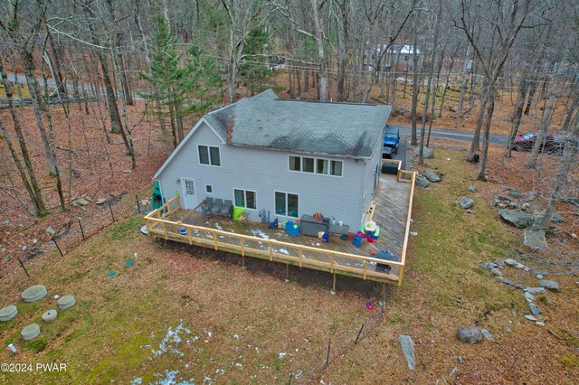 rear view of property with a wooden deck