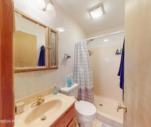 bathroom featuring curtained shower, vanity, tile walls, and toilet