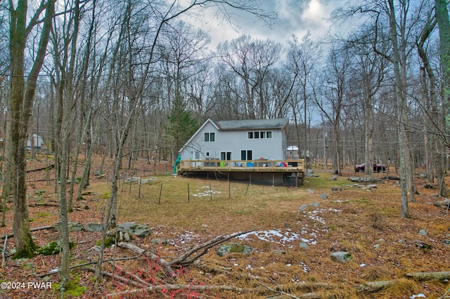 rear view of property with a wooden deck