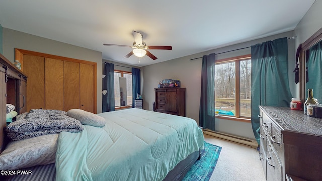 bedroom with ceiling fan, light colored carpet, and a baseboard radiator