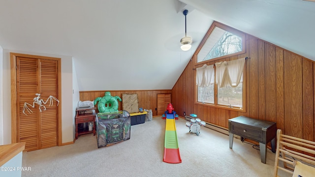 bonus room featuring wood walls, ceiling fan, light colored carpet, and lofted ceiling