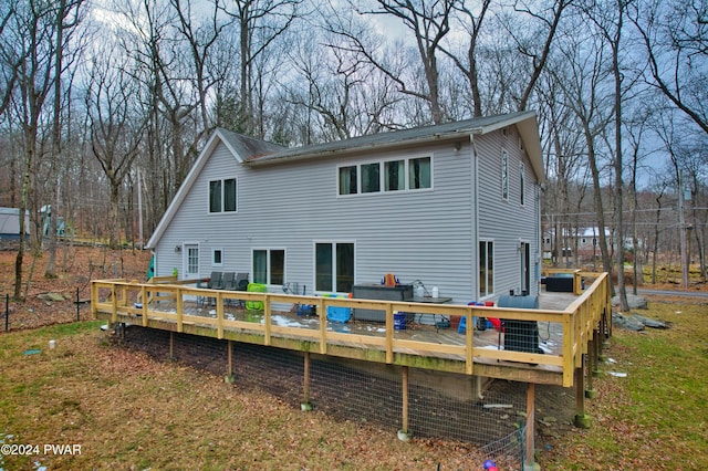 back of property featuring a wooden deck