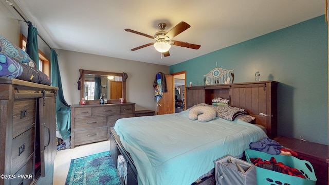 bedroom with ceiling fan and light carpet