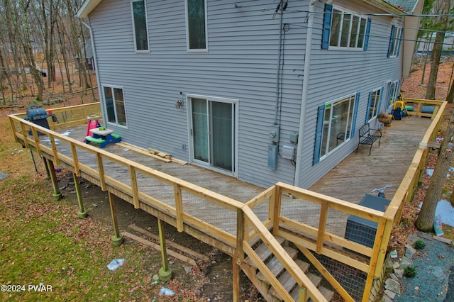 rear view of property with a deck and central AC