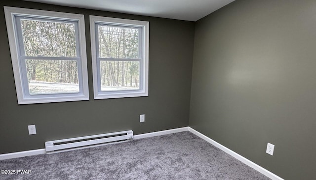 spare room featuring carpet and a baseboard radiator