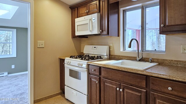 kitchen with a baseboard heating unit, white refrigerator, light tile patterned floors, dark brown cabinets, and butcher block counters